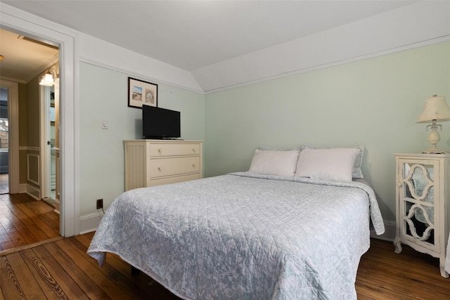 bedroom featuring hardwood / wood-style flooring, baseboards, and lofted ceiling