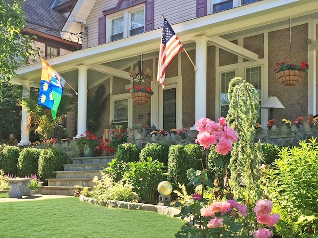 property entrance with a lawn and a porch