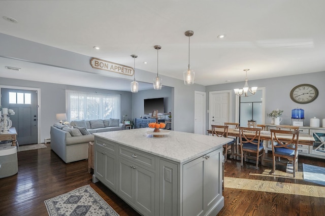 kitchen featuring dark wood-style floors, hanging light fixtures, recessed lighting, and a center island