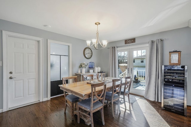 dining area featuring beverage cooler, french doors, an inviting chandelier, and wood finished floors