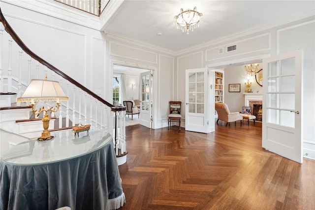 57 Old Orchard Ln, Scarsdale, NY 10583 - foyer with an inviting chandelier, ornamental molding, stairway, french doors, and a decorative wall