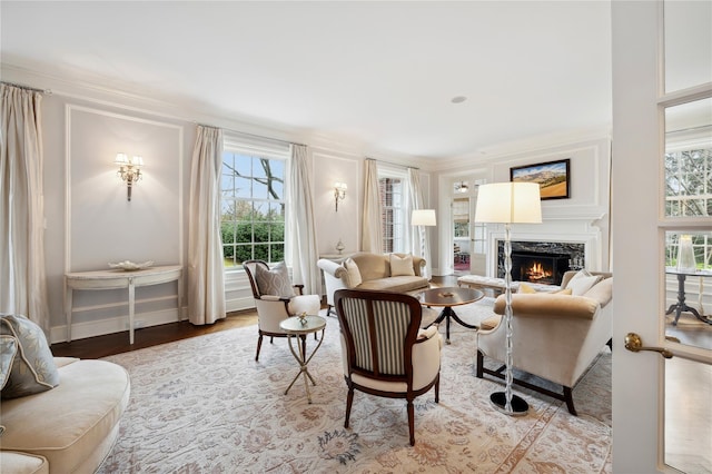 57 Old Orchard Ln, Scarsdale, NY 10583 - living area featuring a high end fireplace, wood finished floors, ornamental molding, and a healthy amount of sunlight