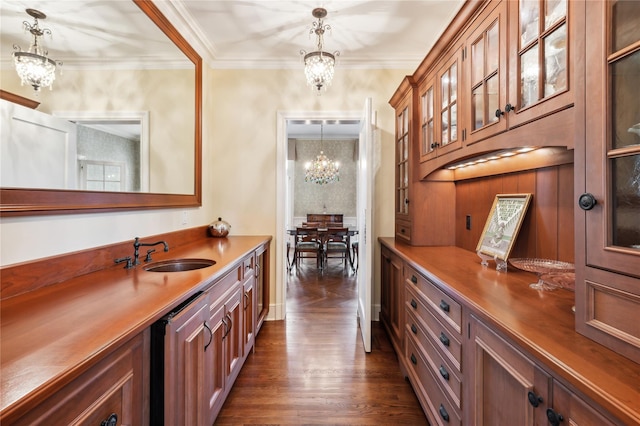 57 Old Orchard Ln, Scarsdale, NY 10583 - interior space with an inviting chandelier, a sink, ornamental molding, dark wood finished floors, and pendant lighting