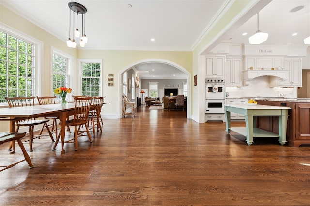 57 Old Orchard Ln, Scarsdale, NY 10583 - dining space featuring ornamental molding, baseboards, arched walkways, and dark wood finished floors