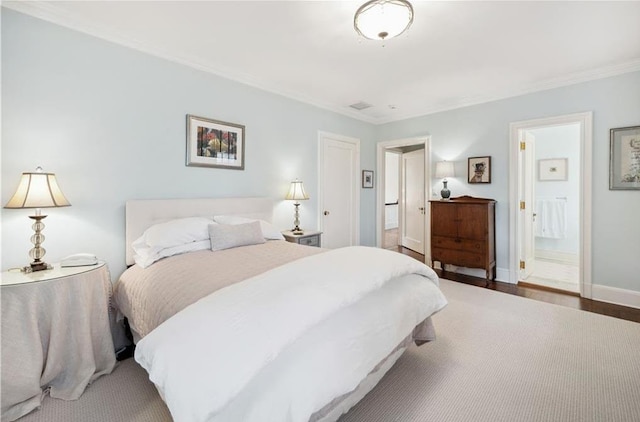57 Old Orchard Ln, Scarsdale, NY 10583 - bedroom with ensuite bath, baseboards, crown molding, and wood finished floors