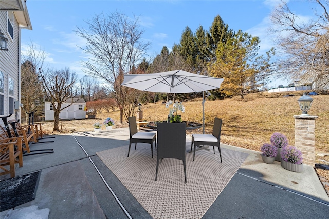 view of patio / terrace with an outbuilding and outdoor dining space