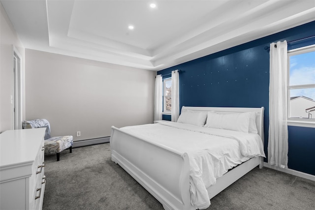 carpeted bedroom featuring a baseboard radiator, baseboards, a tray ceiling, and recessed lighting