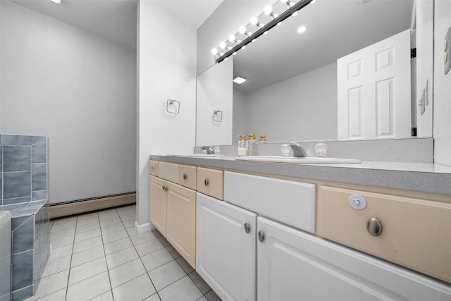 bathroom with double vanity, baseboard heating, a sink, and tile patterned floors