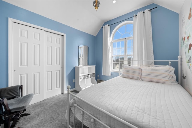 bedroom featuring lofted ceiling, a closet, and carpet