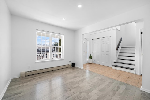 entryway with recessed lighting, wood finished floors, baseboards, stairway, and baseboard heating