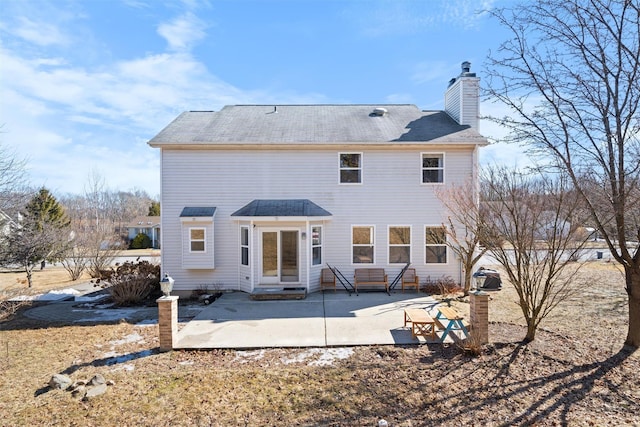 back of property with a patio and a chimney