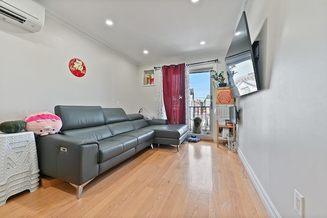 living area featuring baseboards, a wall mounted air conditioner, crown molding, light wood-style floors, and recessed lighting