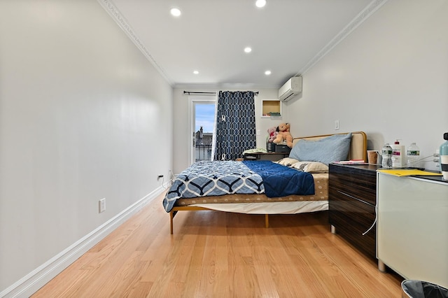 bedroom with baseboards, light wood-style flooring, ornamental molding, and an AC wall unit