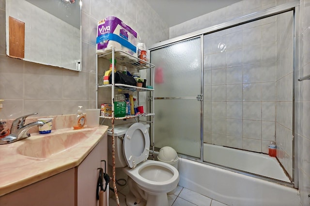 bathroom featuring tasteful backsplash, enclosed tub / shower combo, tile patterned floors, vanity, and tile walls