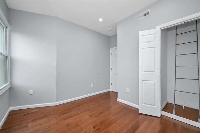 unfurnished bedroom with recessed lighting, visible vents, baseboards, and wood finished floors