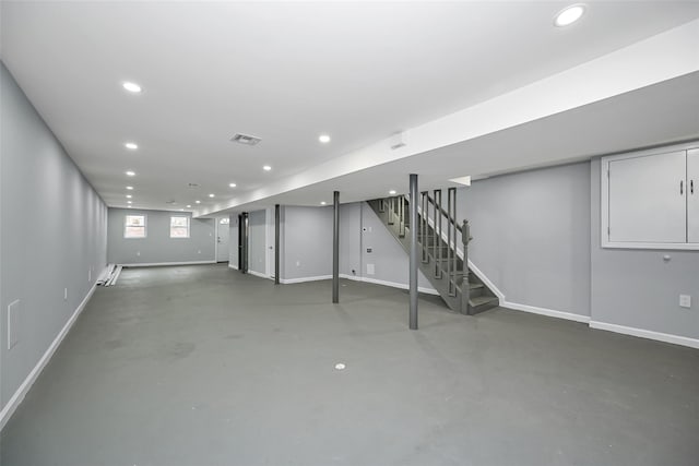 basement featuring baseboards, stairway, visible vents, and recessed lighting