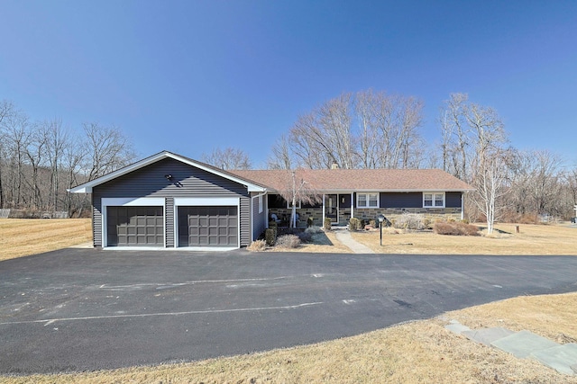 ranch-style home with aphalt driveway and a garage