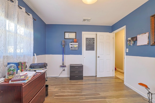 home office with visible vents, baseboards, and wood finished floors