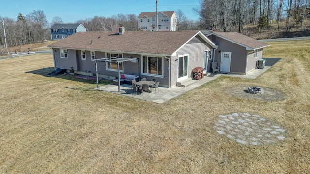 back of house with a patio area, a lawn, entry steps, and a shingled roof