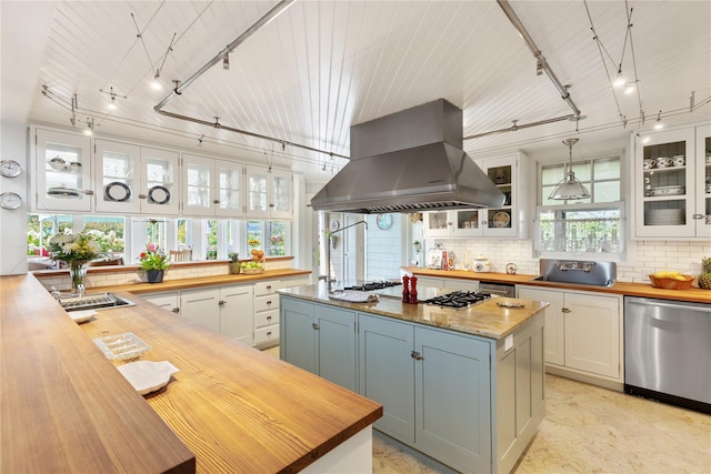 kitchen with dishwasher, white cabinetry, wooden counters, backsplash, and exhaust hood