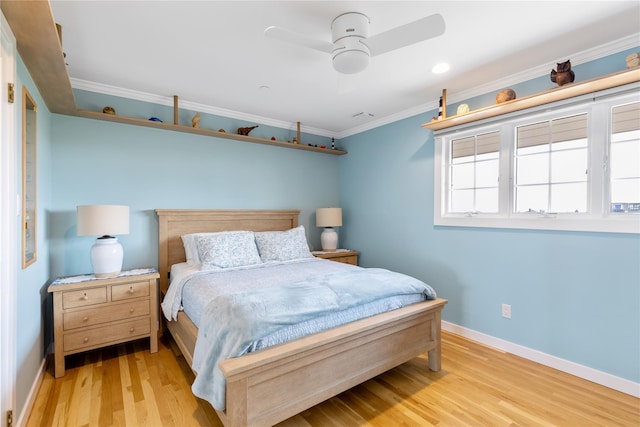 bedroom featuring baseboards, ornamental molding, a ceiling fan, and light wood-style floors