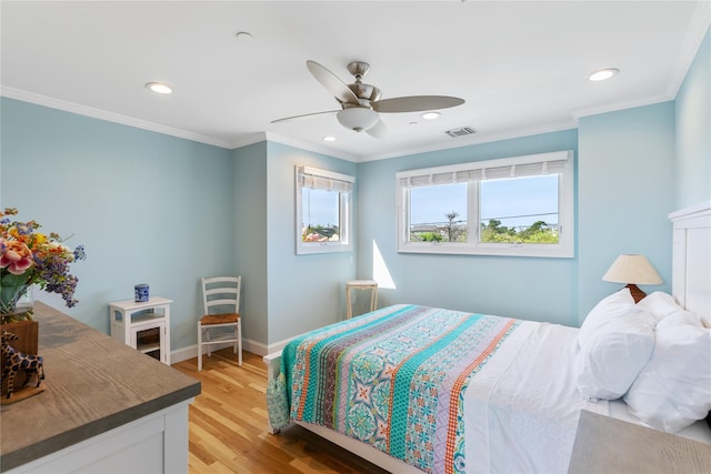 bedroom with a ceiling fan, baseboards, visible vents, light wood-type flooring, and crown molding