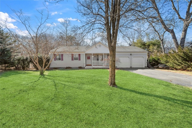 single story home with a front yard, an attached garage, covered porch, and driveway