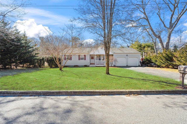 view of front of home featuring an attached garage, concrete driveway, and a front yard