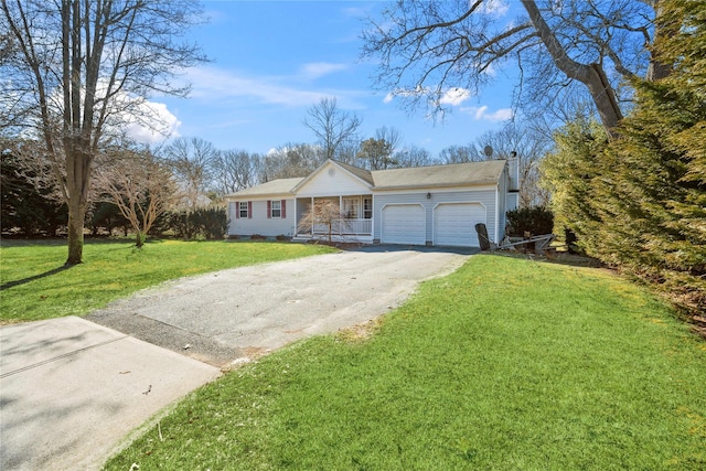 view of front of home with a front lawn, an attached garage, and driveway