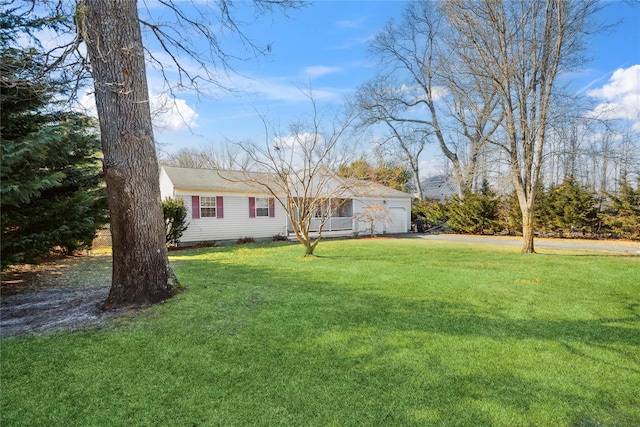 view of front of home with a garage, driveway, and a front yard