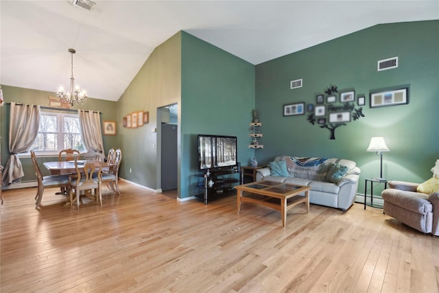 living room with a chandelier, visible vents, light wood-style flooring, and lofted ceiling