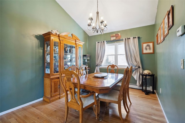 dining room with lofted ceiling, an inviting chandelier, light wood finished floors, a baseboard radiator, and baseboards