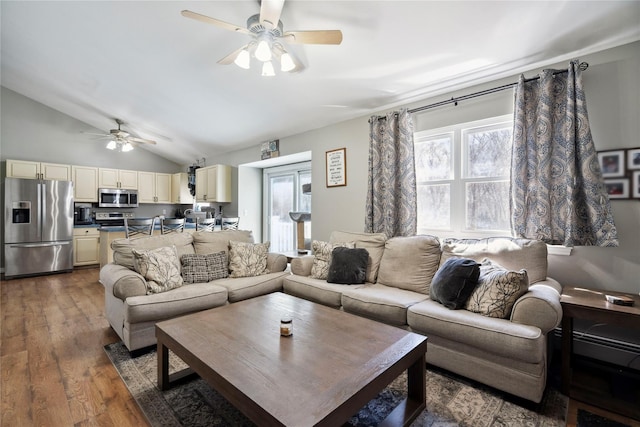 living room featuring dark wood finished floors, ceiling fan, and vaulted ceiling