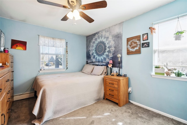 bedroom with a baseboard radiator, multiple windows, carpet, and baseboards