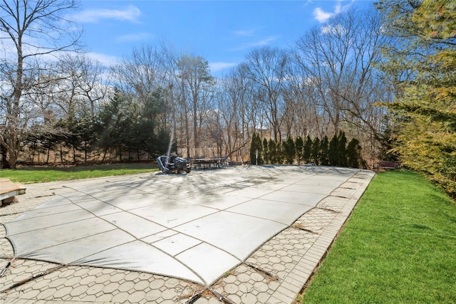 view of pool featuring a yard and a patio area