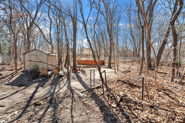 view of yard featuring a storage unit and an outdoor structure