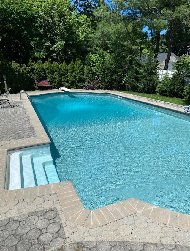 outdoor pool featuring a patio