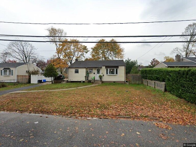 view of front of property with fence and a front yard