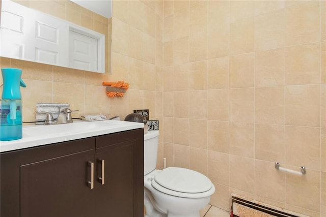 bathroom featuring tasteful backsplash, toilet, a baseboard radiator, vanity, and tile walls