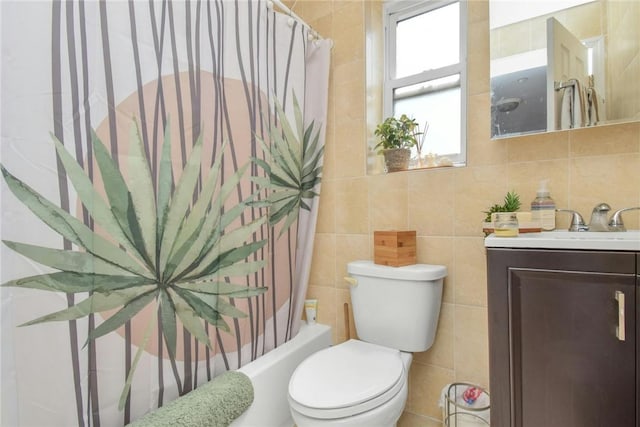 full bathroom featuring toilet, tile walls, vanity, and shower / bathtub combination with curtain