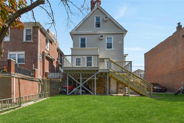 rear view of property featuring stairway, a lawn, a wooden deck, and fence