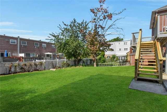 view of yard with stairs and fence