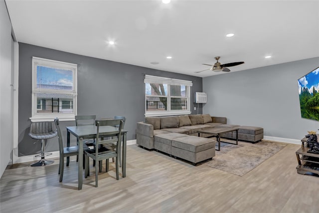 living room with recessed lighting, light wood-style flooring, and baseboards