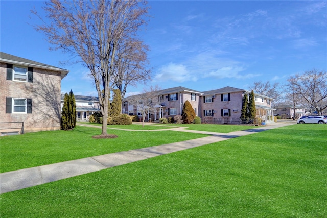 view of property's community featuring a yard and a residential view