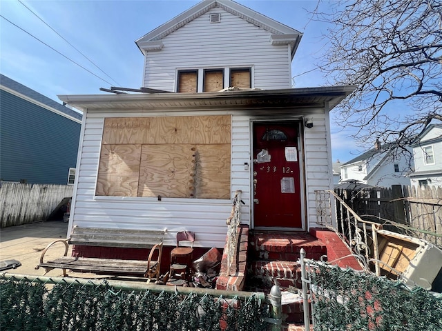 view of front of house featuring fence