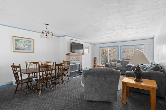 carpeted living room featuring a notable chandelier, a fireplace, and baseboards