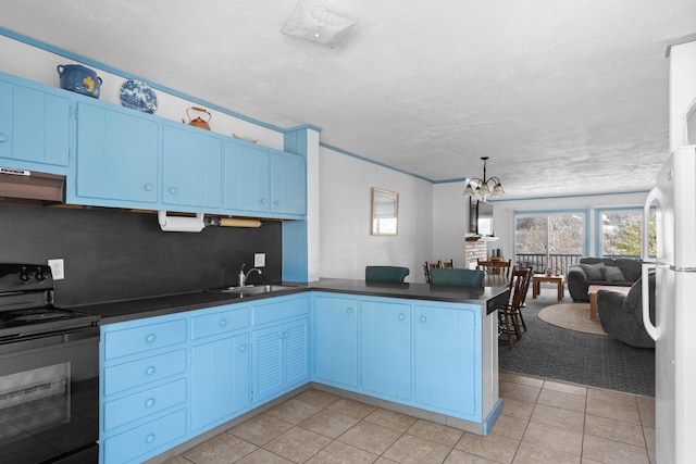 kitchen with a peninsula, a sink, black electric range, freestanding refrigerator, and dark countertops