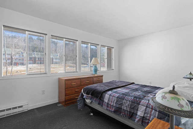 bedroom with carpet floors, a baseboard radiator, multiple windows, and baseboards