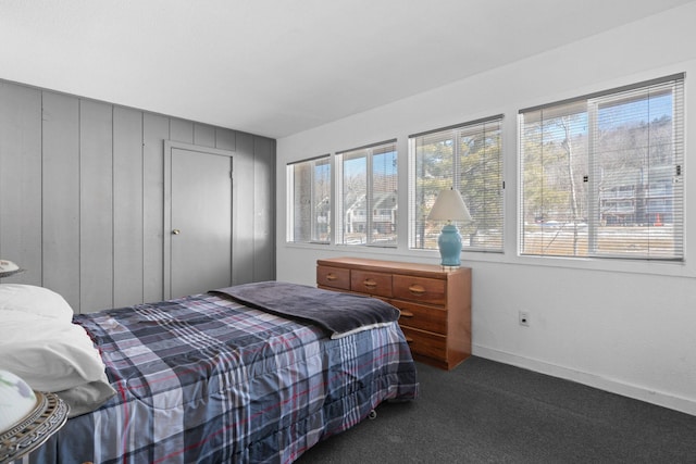 bedroom with carpet flooring and baseboards