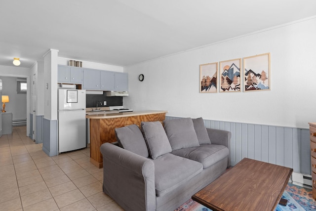 living room featuring wainscoting and light tile patterned flooring